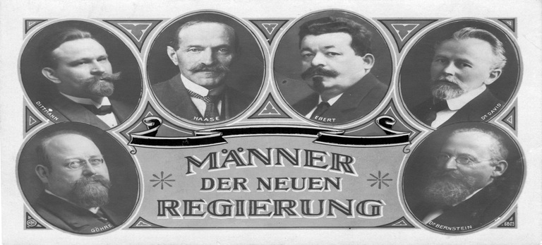 Die zeitgenössische Postkarte zeigt unter dem Motto 'Männer der neuen Regierung' Porträts der sozialdemokratischen Politiker Wilhelm Dittmann, Hugo Haase, Friedrich Ebert, Eduard David, Paul Göhre, Eduard Bernstein